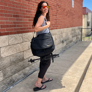 Trombone woman with black mute bag walking